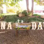 A wooden sign with the word "Gina Dave" on it available for marquee letter rental.