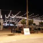 An outdoor parking lot with hanging lights