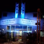 A building with blue LED on top of their entrance