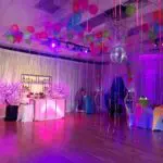 A party room adorned with vibrant balloons and eye-catching decorations, available in Las Vegas.