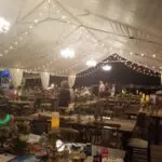 A tent set up with tables and chairs, available for Chandelier & Lamp Post Rental in Las Vegas.