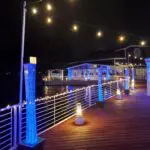 A dock with LED lights on it at night.