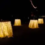 A group of tables are lit up at night with the help of uplight rentals in Las Vegas.