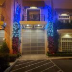 A building is adorned with twinkling blue and red lights.