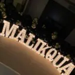 A black and gold "maliqoua" marquee letter rental.