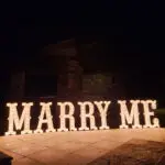 A Marquee Letter Rental sign that says marry me, beautifully lit up.