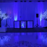 An indoor event with dark blue light setup