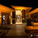 The entrance to a home in Las Vegas is lit up at night with uplight rentals.