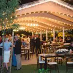 An event with indoor and outdoor tables and chairs for their guests 