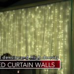 A room with curtain walls and green lights.