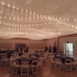 A spacious room at LDS Church in Las Vegas, elegantly arranged with tables and chairs for various events.