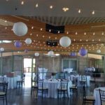 An enchanting wedding reception at Springs Preserve Las Vegas illuminated by beautiful purple paper lanterns gracefully hanging from the ceiling.