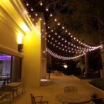 Event Lighting at JW Marriott Las Vegas, featuring a patio adorned with string lights hanging over tables and chairs.