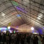 People gathered inside a conference tent