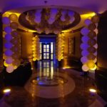 A hallway decorated with gold and white balloons, enhancing the atmosphere for an event at the Las Vegas strip.