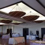 A banquet room decorated with tables and chairs, enhanced by event lighting at Paiute Las Vegas.