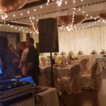 A wedding reception with event lighting at Paiute Las Vegas, featuring a DJ in the background.