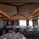 A room at Red Rock Country Club Las Vegas, set up with tables and chairs for a wedding.