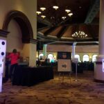 Event Lighting at JW Marriott Las Vegas features a group of people standing in front of a table with dices on it.