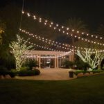 An elegant wedding reception at JW Marriott Las Vegas, adorned with enchanting string lights and accented by beautiful palm trees.