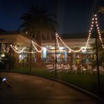 A mesmerizing wedding ceremony at night with palm trees and magical string lights, creating a romantic ambiance. Exquisite event lighting by CiliLake in Las Vegas adds a touch of enchantment to