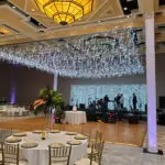 Event Lighting at Westin Lake Las Vegas: A spacious ballroom adorned with illuminating lights and elegantly set tables.