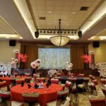 A large ballroom decorated with red and white balloons, enhanced by event lighting at Siena Las Vegas.