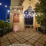 A courtyard adorned with sparkling string lights and an enchanting archway.