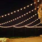 Event lighting hanging over a patio at night at Lake Las Vegas Sports Club.