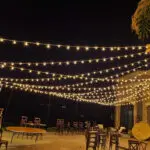 Event Lighting at Lake Las Vegas Sports Club featuring a patio with string lights hanging over elegant tables and chairs.