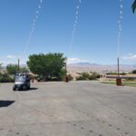 Golf carts at an event with mountains in the background, lit by event lighting at Revere Las Vegas.