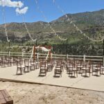 An enchanting wedding ceremony set up on a deck at Mt Charleston Las Vegas, with breathtaking mountains in the background.