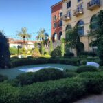 A garden in front of a building with trees and shrubs transformed with event lighting at Hilton Lake Las Vegas.