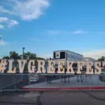 A marquee letter sign that says lvgreekfest in front of a fence.