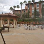 An outdoor area with tables and chairs in front of a building, perfect for Event Lighting at Westin Lake Las Vegas.