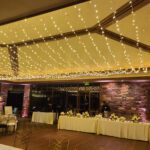 A wedding reception at Red Rock Country Club Las Vegas with event lighting and lights hanging from the ceiling.