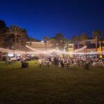 A wedding reception at the palms resort in palm springs, california featuring event lighting.