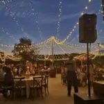 A wedding reception under string lights at dusk in California, enhanced by event lighting at Lotus House Las Vegas.