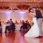 A bride and groom sharing their first dance at a wedding reception enhanced by event lighting at Paiute Las Vegas.