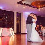 A bride and groom enjoying their first dance under the beautiful event lighting at their wedding reception at Paiute Las Vegas.