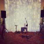 An event lighting set up with a stage, guitar, and speakers at CiliLake Las Vegas.