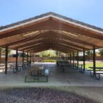 A covered picnic area with tables and chairs for events.