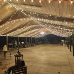 A wooden covered patio adorned with string lights, perfect for event lighting at LDS Church Las Vegas.