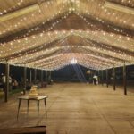 A stunning wedding reception under a covered area with mesmerizing string lights, enhanced by the expert event lighting services at LDS Church Las Vegas.