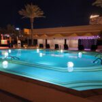 The LED pool is lit up at night for rental.