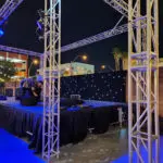 A specialty DJ setup in a city at night with captivating event lighting.