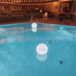 Experience the mesmerizing allure of our LED pool orb rental, featuring a stunning pool adorned with captivating lighted balls in the middle.